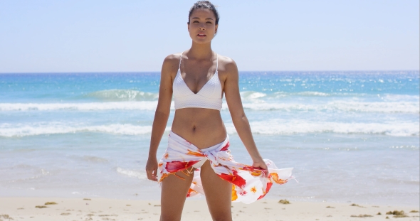 Young Woman In a Bikini Standing On a Beach