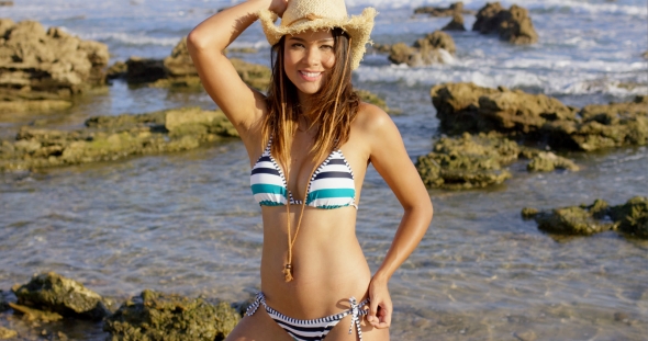 Sexy Young Woman In a Straw Hat And Bikini