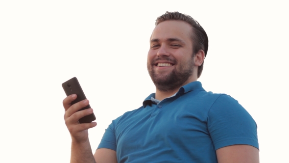 Smiling Bearded Man Using Phone