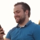 Smiling Bearded Man Using Smartphone Outdoor - VideoHive Item for Sale