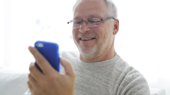 Old Man Having Video Call On Cellphone At Home 20