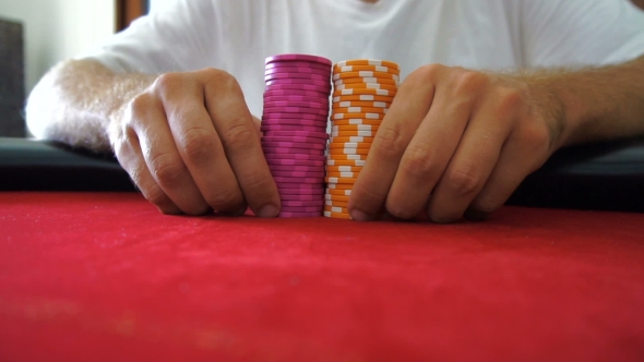 Pushing Pile Of Poker Chips Towards Camera