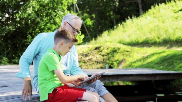 Grandfather And Boy With Tablet Pc In Country 31