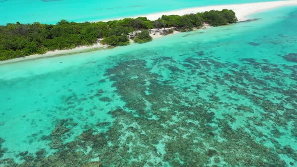 Aerial above travel of idyllic seashore beach adventure by blue sea with white sand background of a 