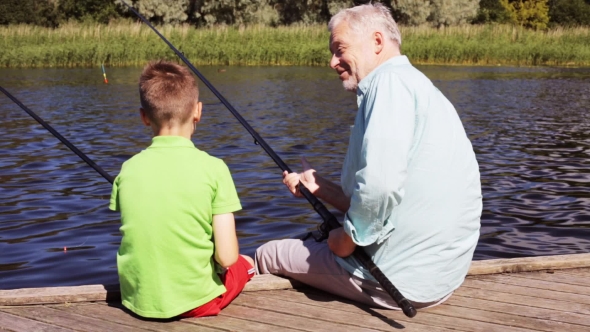 Grandfather And Grandson Fishing On River Berth 22