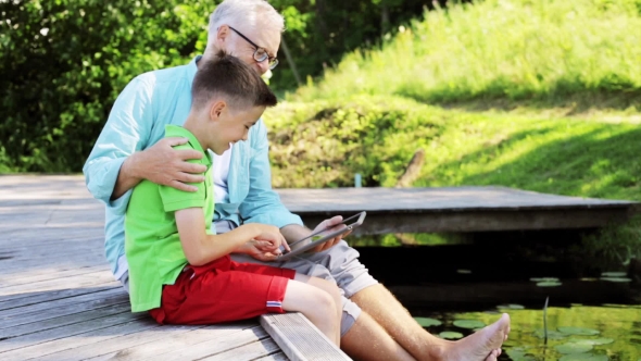 Grandfather And Boy With Tablet Pc In Country 33