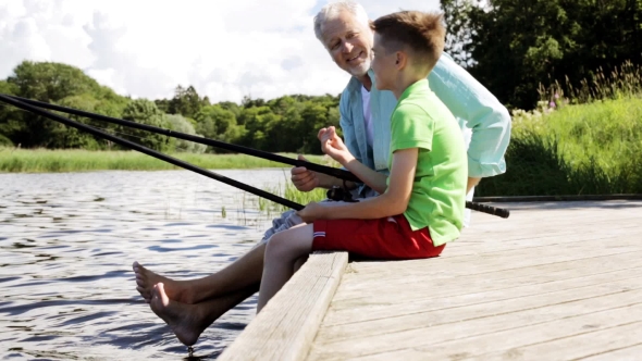 Grandfather And Grandson Fishing On River Berth 13