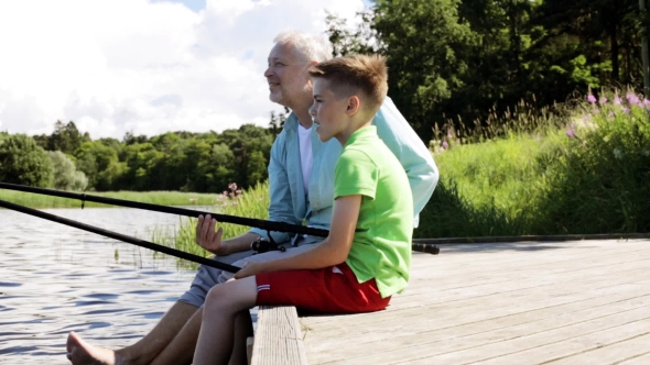 Grandfather And Grandson Fishing On River Berth 16