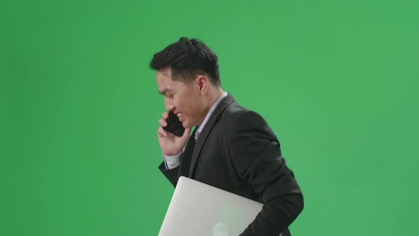 Asian Business Man Talking On Mobile Phone While Walk And Run On Green Screen Chroma Key