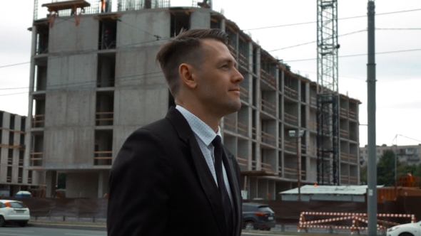 Businessman Walking Near Construction