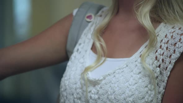 Up close slow motion of teenage girl missing part of left arm at her locker.