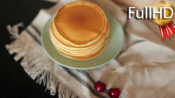 Pile of Fresh Pancakes on a Plate on a Towel