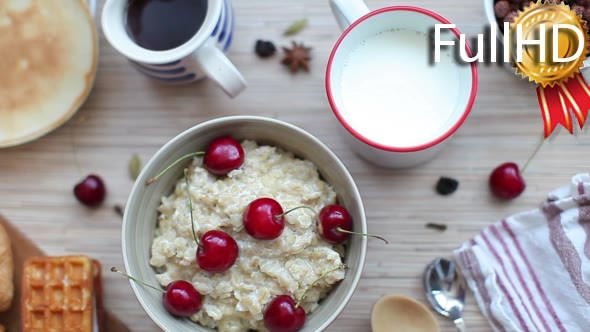 Breakfast of Porridge With Cherries and Pastry