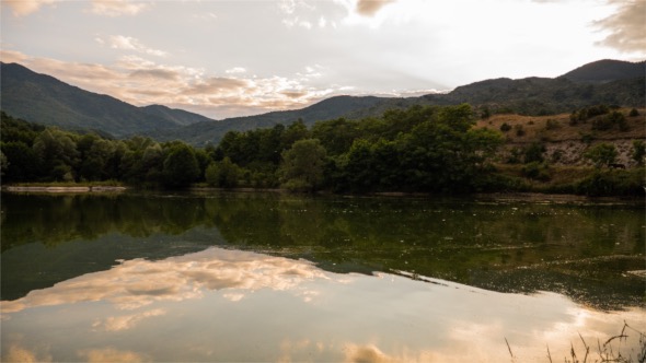 Lake With Reflection Of Clouds During Sunset