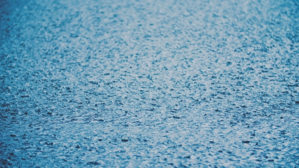 Rain Drops On Water. Heavy Rain On Water