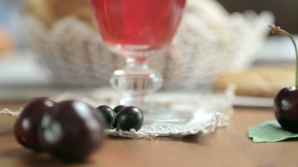 Fresh Cherries Around The Glass Of Fruit Drink. Table Setting.