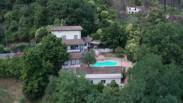 Flying up to small Mediterranean villa with pool