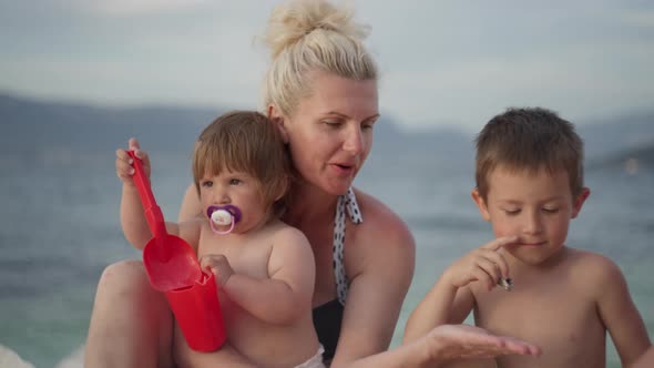 Grandma Plays with Children During Summer Vacation at Sea