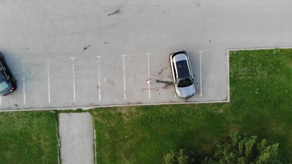 Aerial Drone Shot of Young Handsome Casual Businessman Uses Smartphone in the City