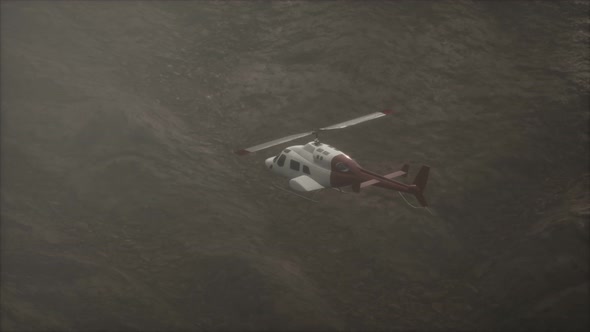 Extreme Slow Motion Flying Helicopter Near Mountains with Fog