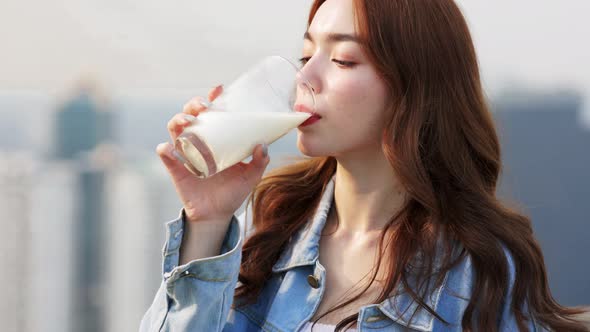 Asian young woman drinking milk.