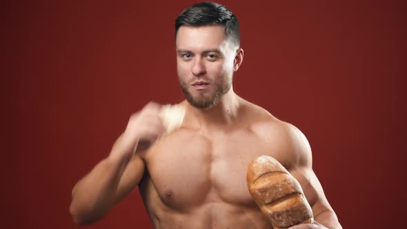 Portrait of bodybuilder eating healthy food. Sportsman choosing special bread important