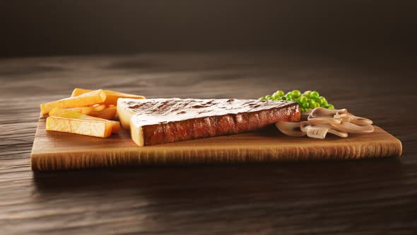 A tasty dish at the restaurant. Steak with french fries sprinkled with salt.