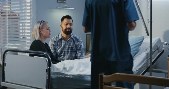 Female Patient Lying in Hospital Bed