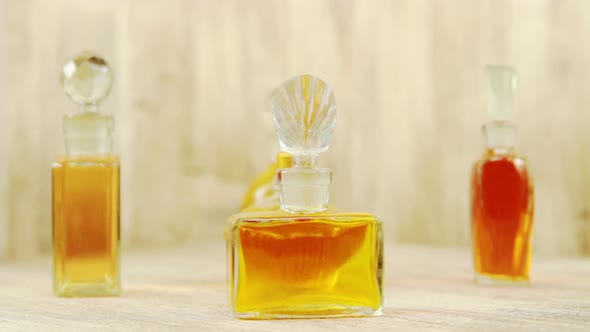 Vintage Bottles Of Perfume In The Wooden Background