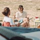 Two men sitting at a camp side table talking - VideoHive Item for Sale
