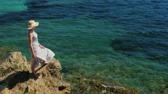 Crane Shot: Woman In Hat Admires The Sea. 