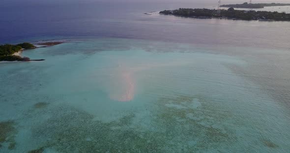 Tropical drone travel shot of a white sandy paradise beach and aqua turquoise water background in 4K