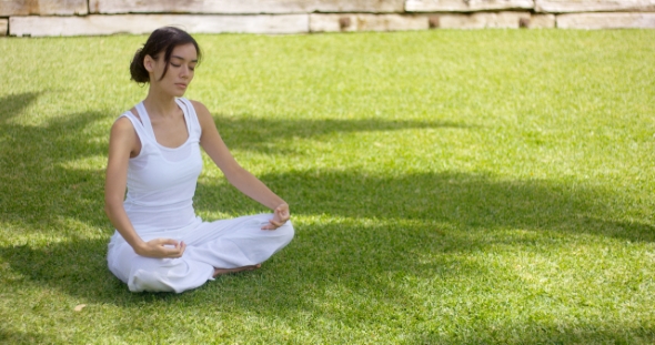 Young Woman Meditating In Nature