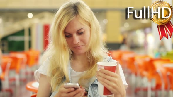 Woman Using Cell Phone at a Shopping Center