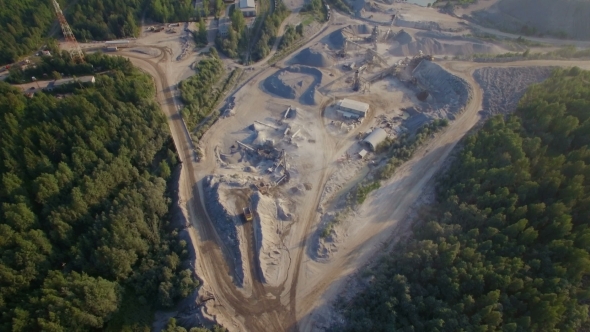 Industrial Trucks Moves Along The Road In The Sand Quarry