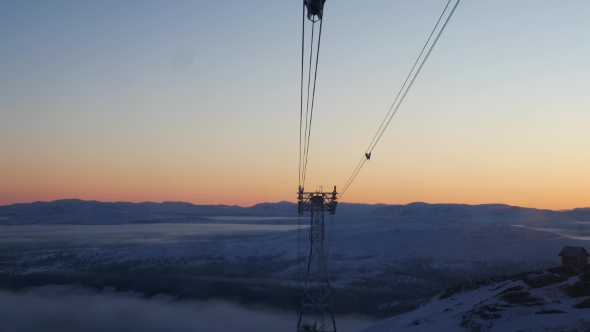 View From Moving Cabin On Oncoming Tower Of Cable Car And Setting Sun. Sweden
