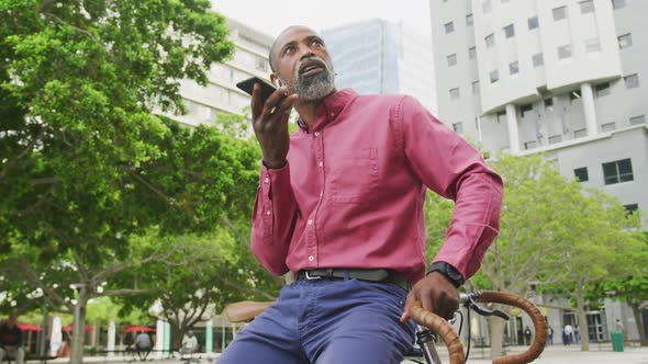 African American man using his phone in the street