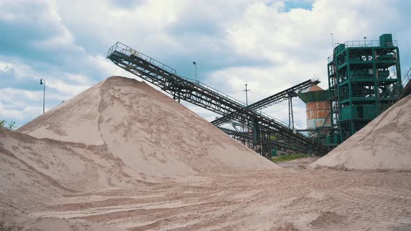 Pile Of Pit Sand With Conveyor Belts At Quarry Site. - panning right shot