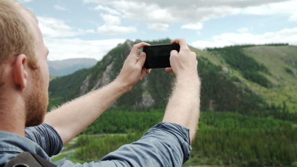 Man Using Smart Phone Take a Photo Mountain View