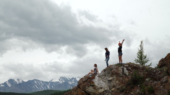 Two People Standing On Top Of a Mountain