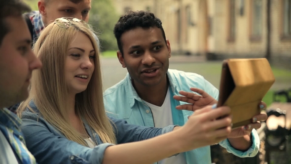  Students Chatting With Friend Using Tablet