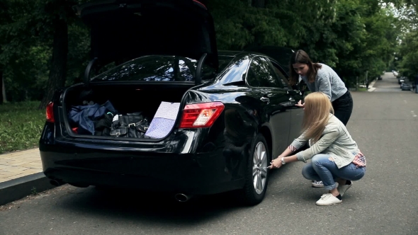Woman Driver Trying To Remove Wheel With Wrench