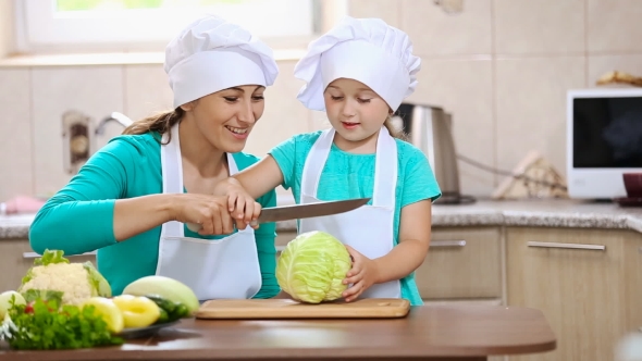 Mother With Her Daughter Cut Cabbage