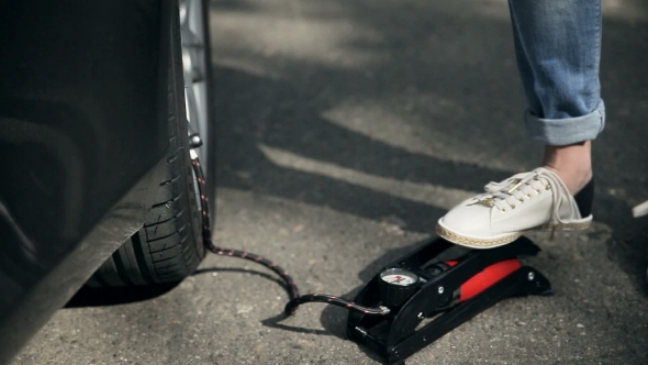  Woman's Foot Inflating Car Tyre With Pump