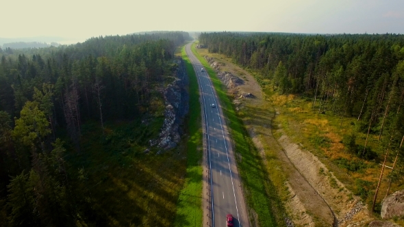 Aerial View Of Car Driving On a Road In The Woods