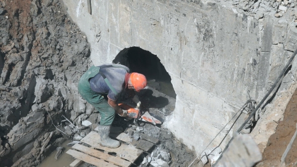 Worker Repairing The Construction Collector