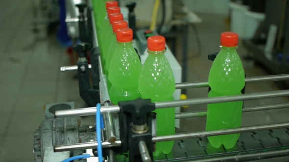 Lemonade Soda Bottles Move Along The Conveyor Belt Are Filled With Packed Twist On The Production