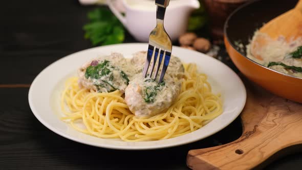 Portion of Delicious Meatballs with Spinach in a Creamy Sauce