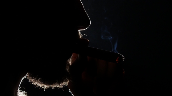 Man Sipping Whiskey From Glass And Smoking. Blacklight. Silhouette. 