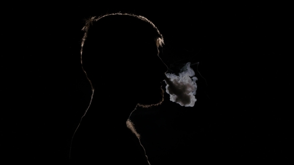Man Smokes an Electronic Cigarette and Exhaling Smoke on Nose Nostrils